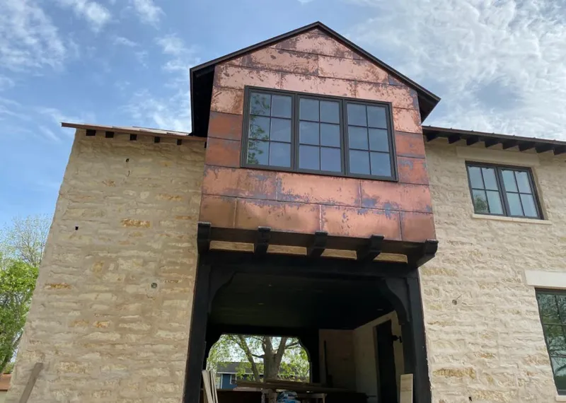 Copper metal panel facade on a stone building for Skylight Installation in Braidwood