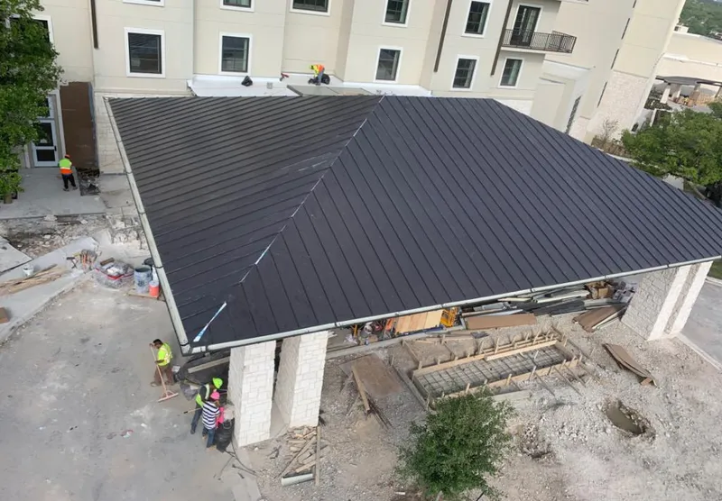 Metal roofing installation team working on a commercial building in Braidwood