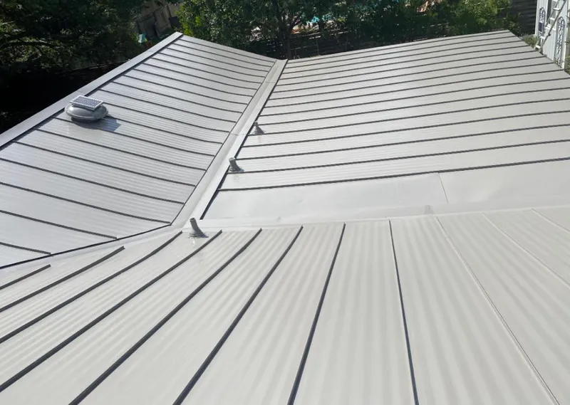Solar attic fan installed on a metal roof for Roof Ventilation in Braidwood